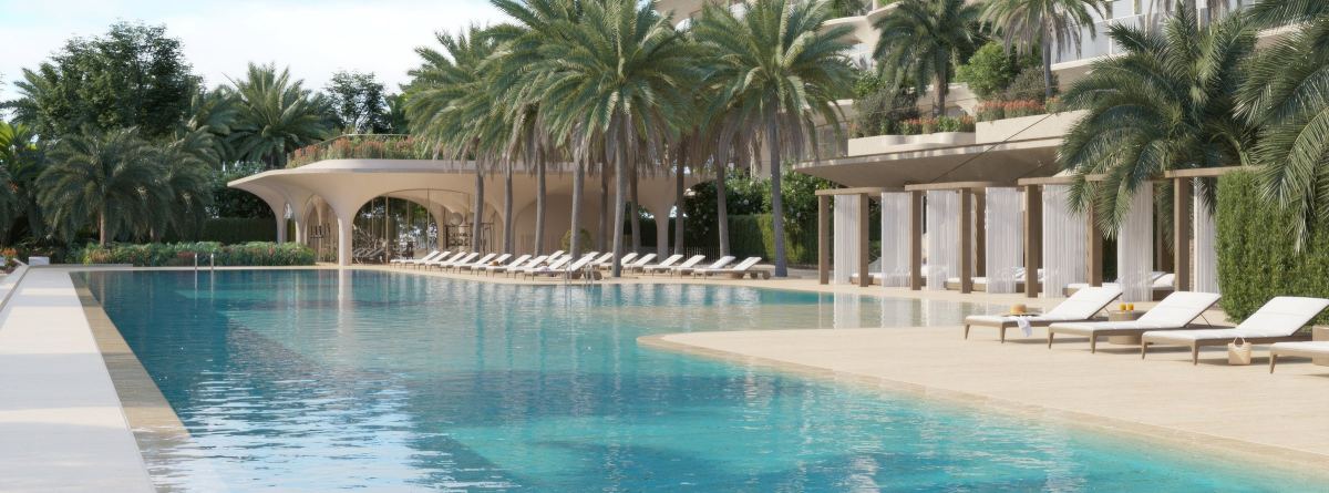 The Olympic pool at Ocean House, lined with palms, cabanas and sun loungers.