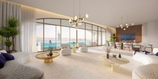 A living room at Ocean House with full-height glazing onto the sea.