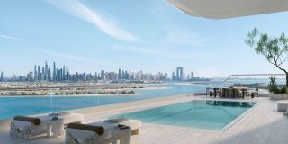 An infinity pool terrace at ORLA looking across the Palm to the Dubai skyline.