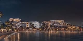 Palm Central lit at night, seen across the water.
