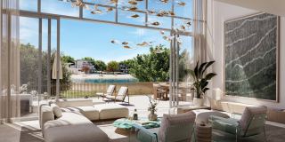 Double-height living room in a four-bedroom townhouse at Palm Central, opening to the garden.