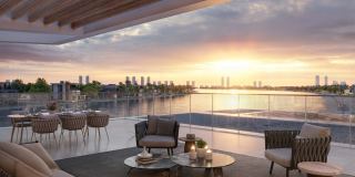 Penthouse terrace at Palm Central at sunset, looking across the water to the mainland.