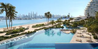 The infinity pool and private beach at Passo, with the Dubai Marina skyline across the water.
