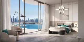 The main bedroom of a two bedroom residence at Passo, opening onto the water and the skyline.