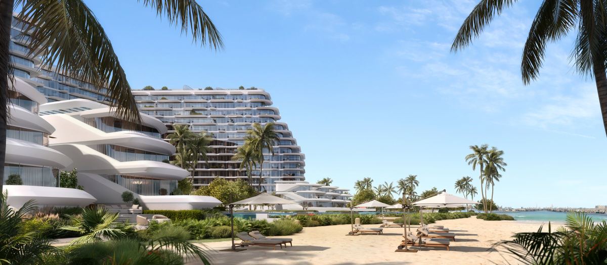 The private beach at Passo, with loungers on the sand and the stepped terraces of the building behind.