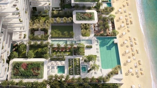 Pools, gardens and a beach on the Palm Jumeirah crescent at ORLA, Dorchester Collection, seen from above