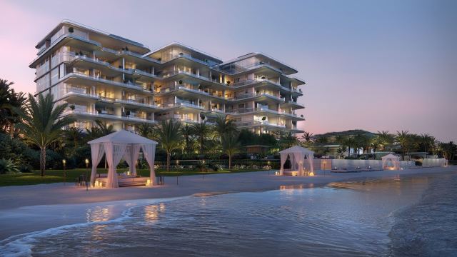 The beach and cabanas below ORLA, Dorchester Collection on the Palm Jumeirah crescent at dusk
