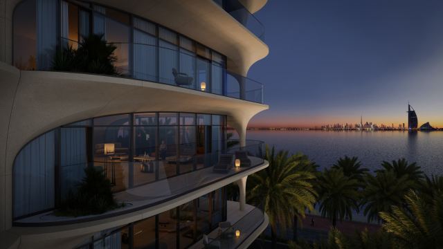 A balcony at Ocean House at dusk, looking across the water to the Burj Al Arab and the Dubai skyline