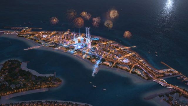 Palm Jebel Ali at night, with fireworks over the head of the island