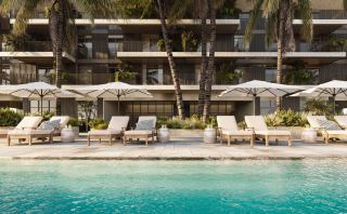 Swimming pool and loungers below the apartment terraces at Rise by Athlon.
