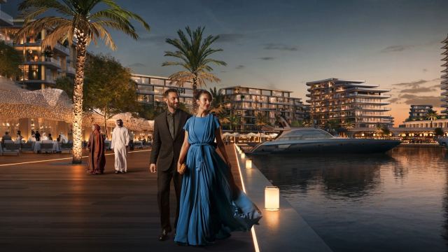 The promenade beside the marina at Marsa Al Saadiyat at night, with yachts berthed alongside
