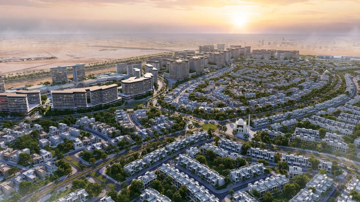 Aerial view of Sobha Sanctuary at sunset, with villa streets, apartment buildings and the community mall along the main road.