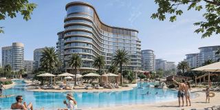 The resort pool at Sobha Sanctuary, with loungers and parasols below the curved community building.