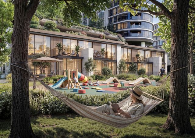 Resident reading in a hammock strung between mature trees beside garden homes at Sobha Sanctuary.