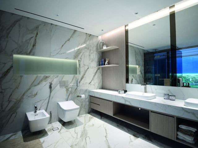 Master bathroom in marble at Sobha Seahaven, with the sea in the window.