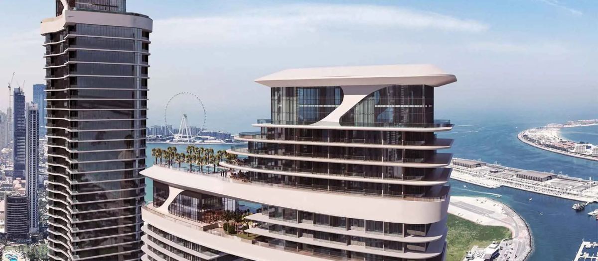 Sobha Seahaven from the air, the towers curving above Dubai Harbour with Ain Dubai beyond.