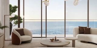 A living room at Soulever with floor-to-ceiling glazing onto the sea.