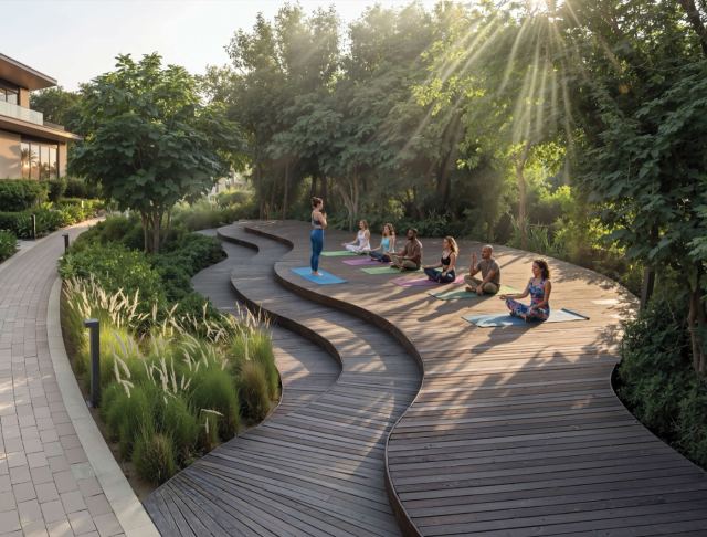 Shaded boardwalk winding through the landscaped wellness loop at Sobha City Abu Dhabi.