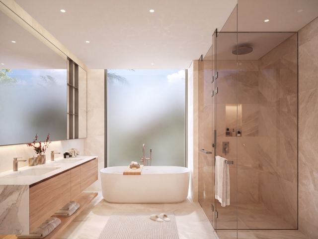 The master bathroom in a Talay villa, with a freestanding bath and a glass shower.