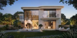 A two-floor Talay villa at dusk, with its terrace and garden lit.