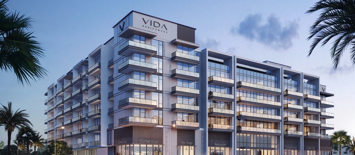 Vida Residences Saadiyat Island at dusk with the building signage lit