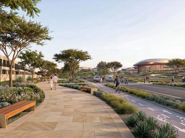 Landscaped pedestrian streets on Hudayriyat Island with the arena beyond.