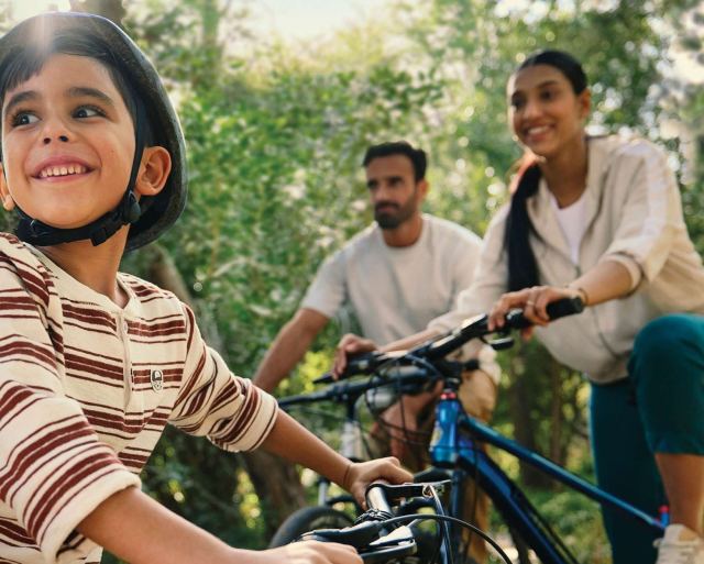 A family cycling the nature trails at The Wilds.