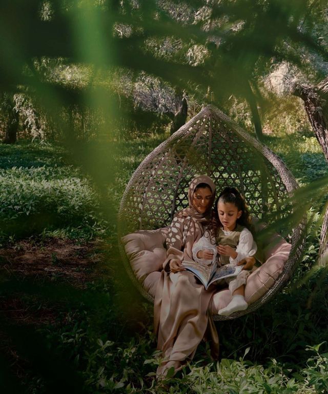 Reading in a hanging chair in the gardens at The Wilds.