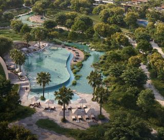 The natural swimming pool and amenity gardens at The Wilds seen from the air.